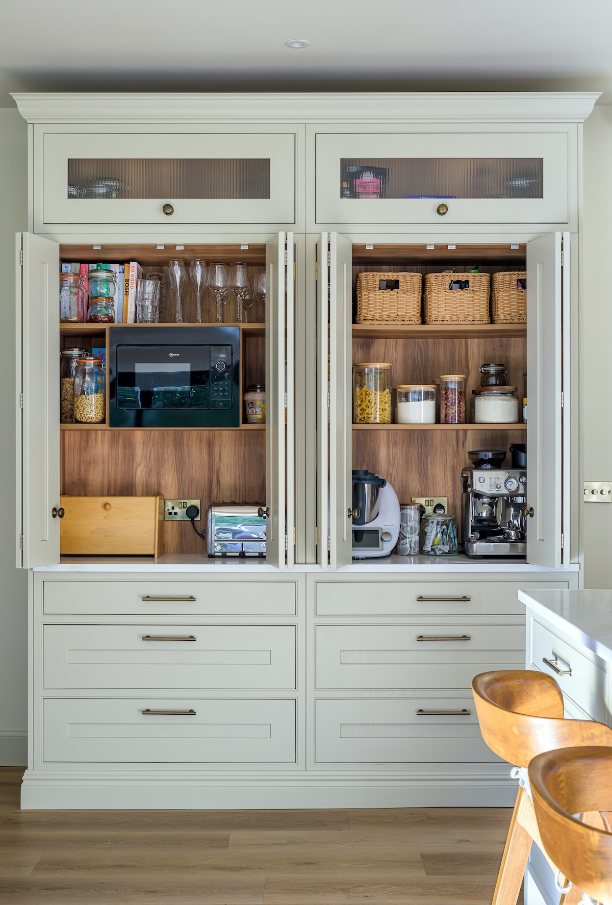 Beautifully photographed Shaker-style kitchen with soft green cabinetry, marble surfaces and warm natural light — timeless design by Mascari Design.
